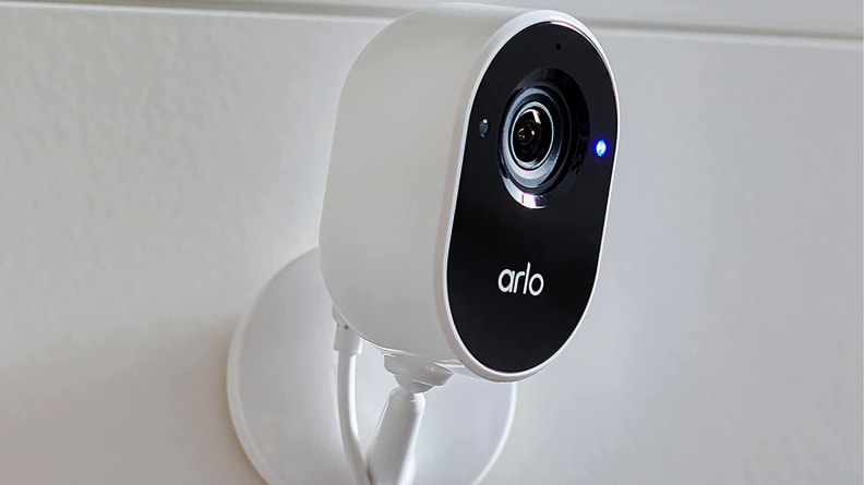 White and black smart camera mounted on wall.